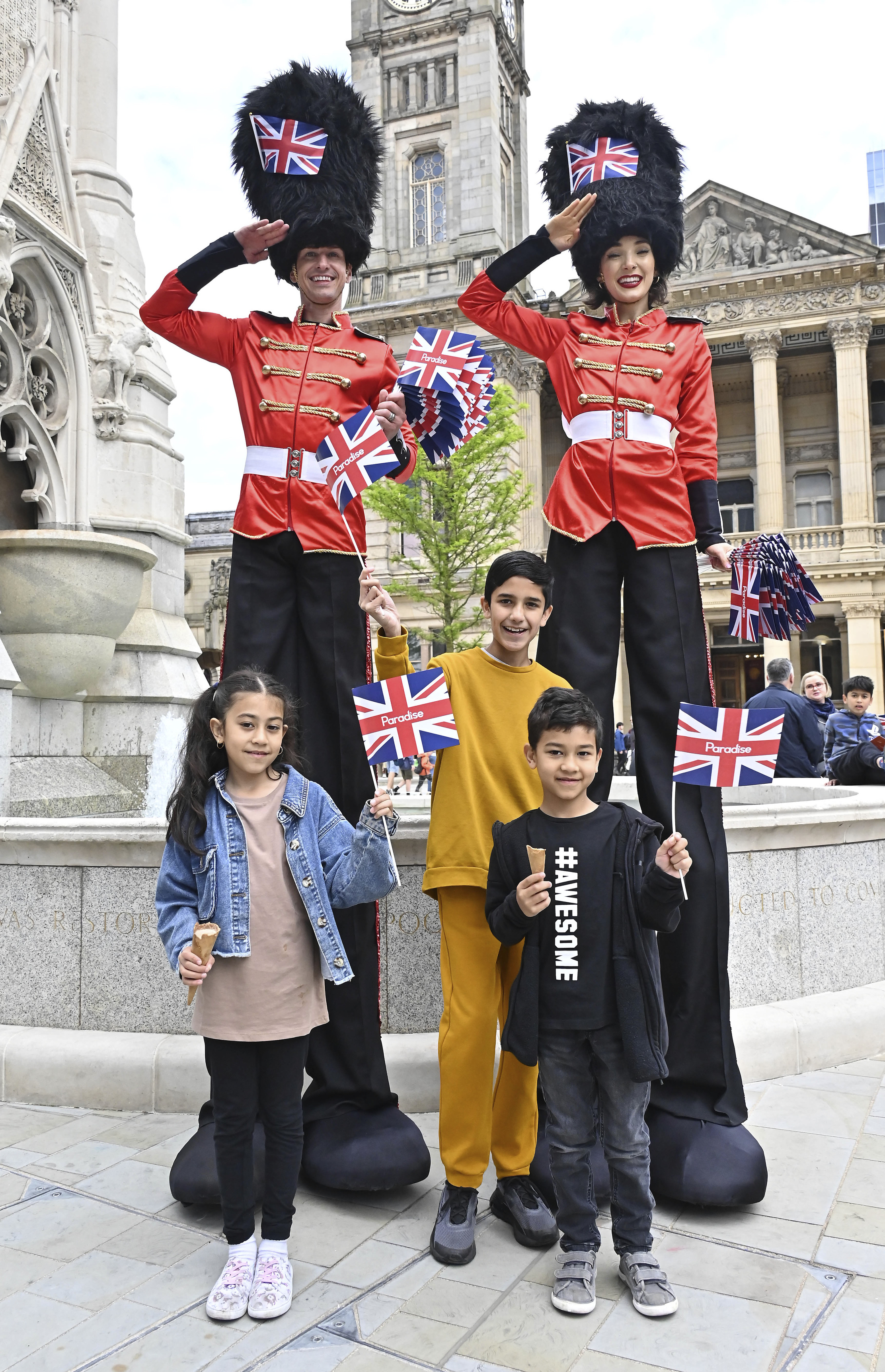 Queens guard stilt walkers at Paradise Family Day.