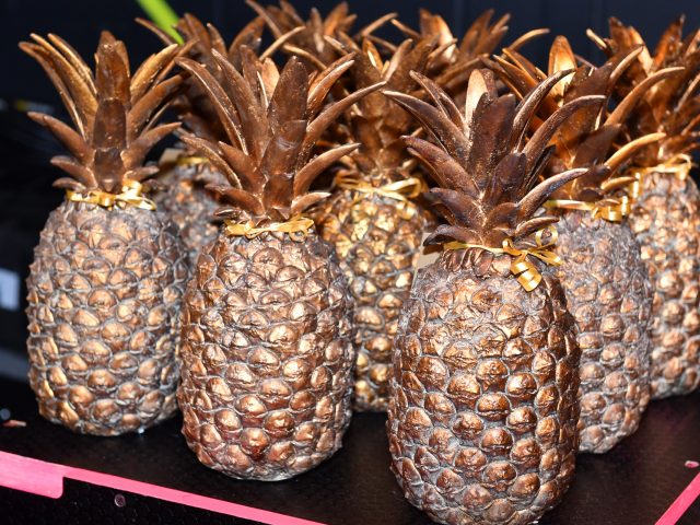 Pineapple shaped trophies in a bronze colour.