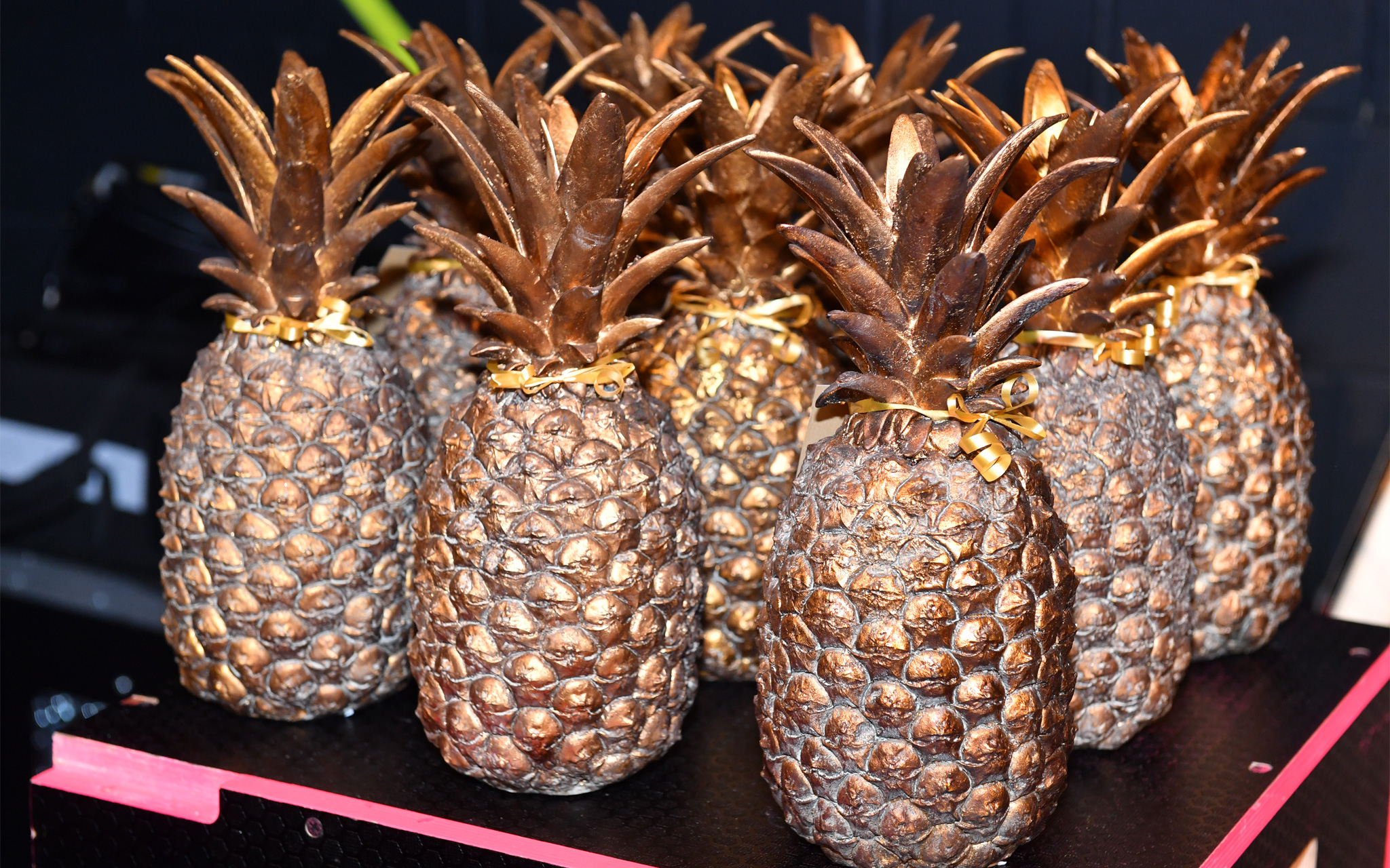 Pineapple shaped trophies in a bronze colour.