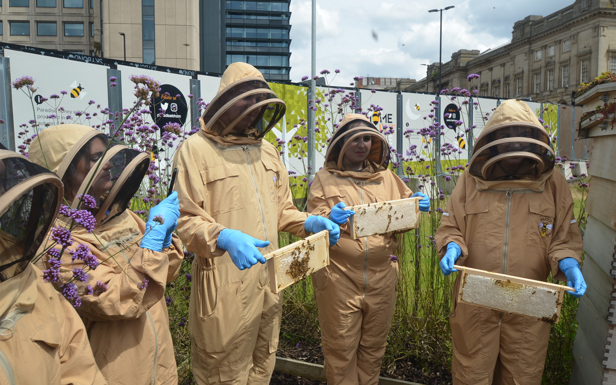 Beekeeping course attendees see the honeycomb up close.