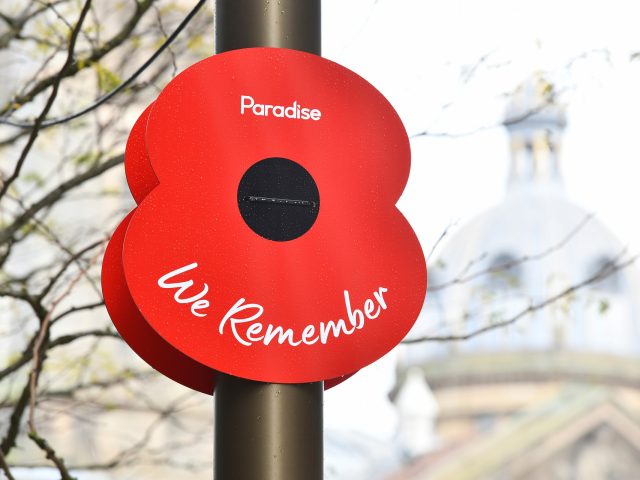 A large poppy attached to a lampost with the words 'Paradise, We remember'.