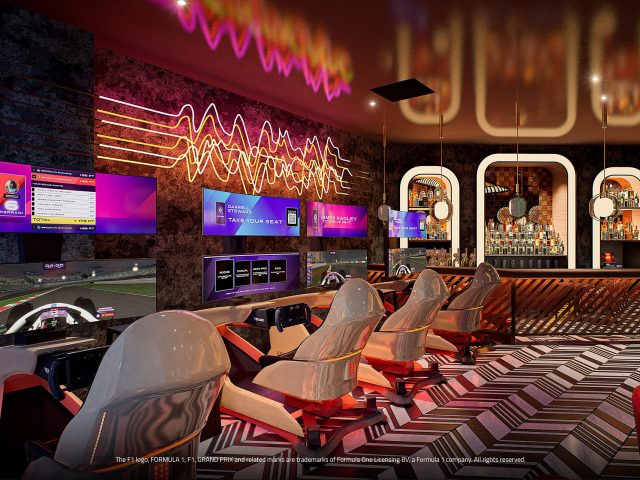 Driving video game booths, with full curved surround screen, steering wheel and pedals controllers and large speaker sound system, with a lavish bar area in the background.