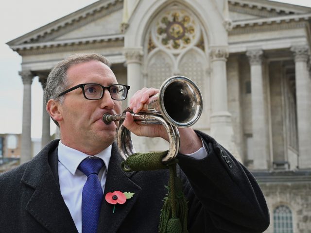 Jonathan Clements, PwC, plays the Last Post on bugle in Chamberlain Square, Paradise.