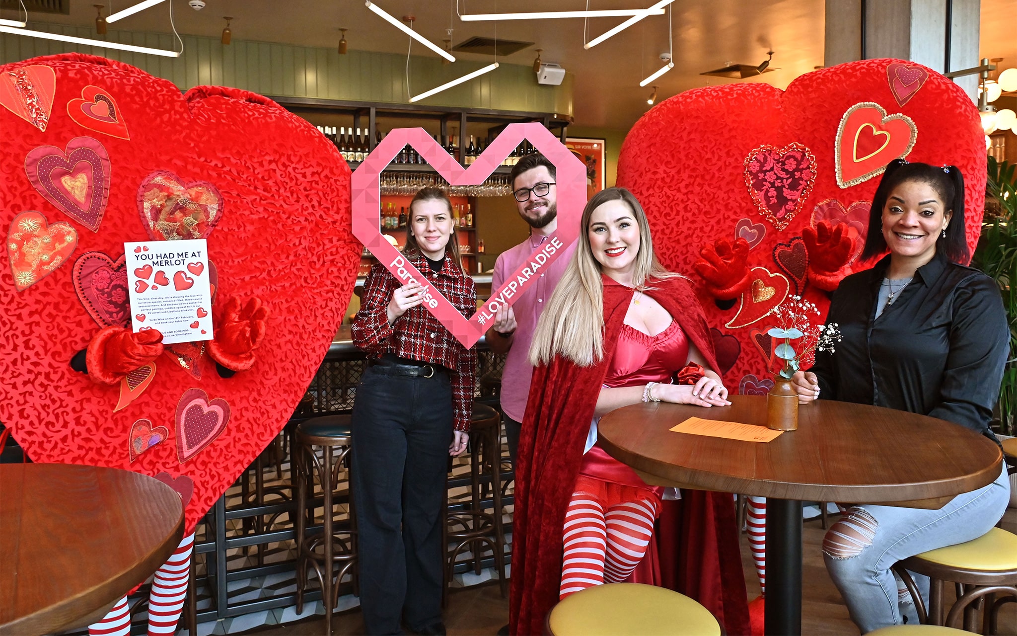 People in love heart costumes handing out bags of sweets in Albert's Schloss at Paradise Birmingham.