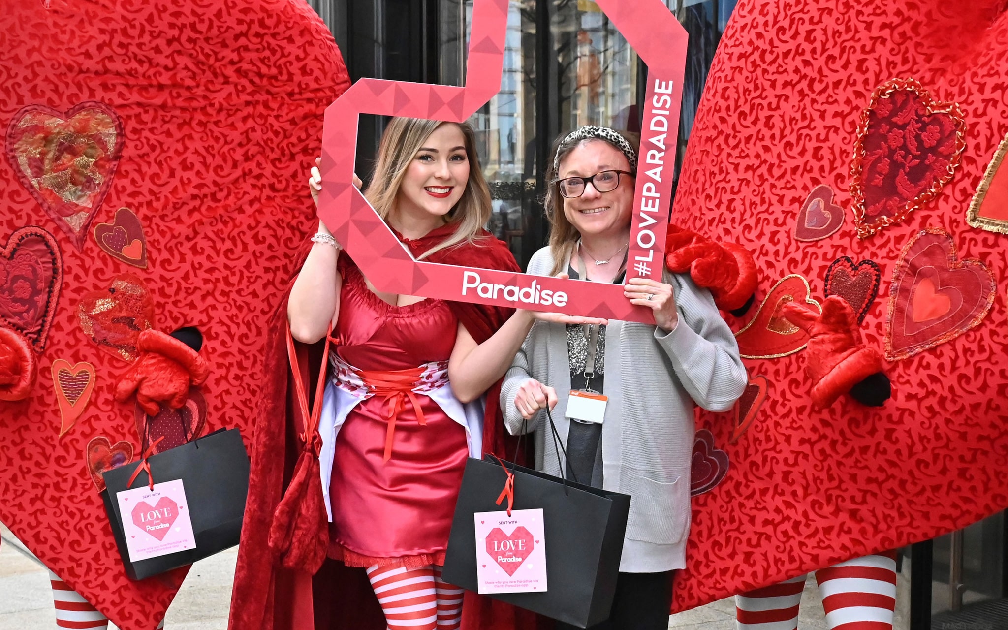 Gemma Wood, PwC, with the Paradise love hearts costumes outside One Chamberlain Square.