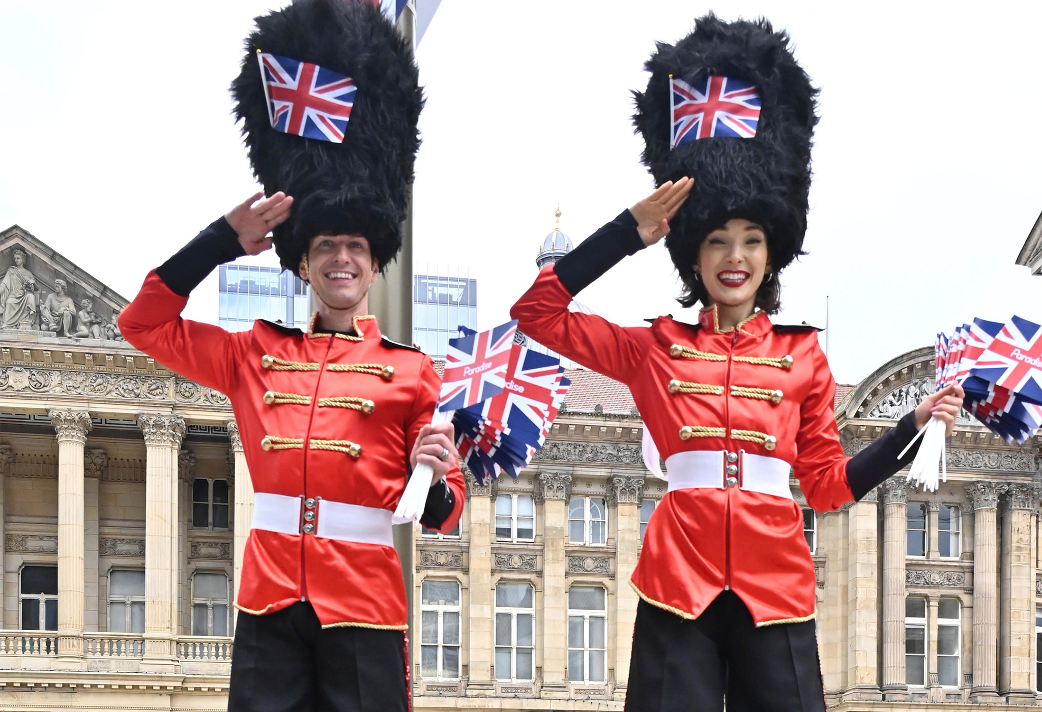 Stilt walkers in Guards Men outfits saluting. In Chamberlain Square, Paradise.